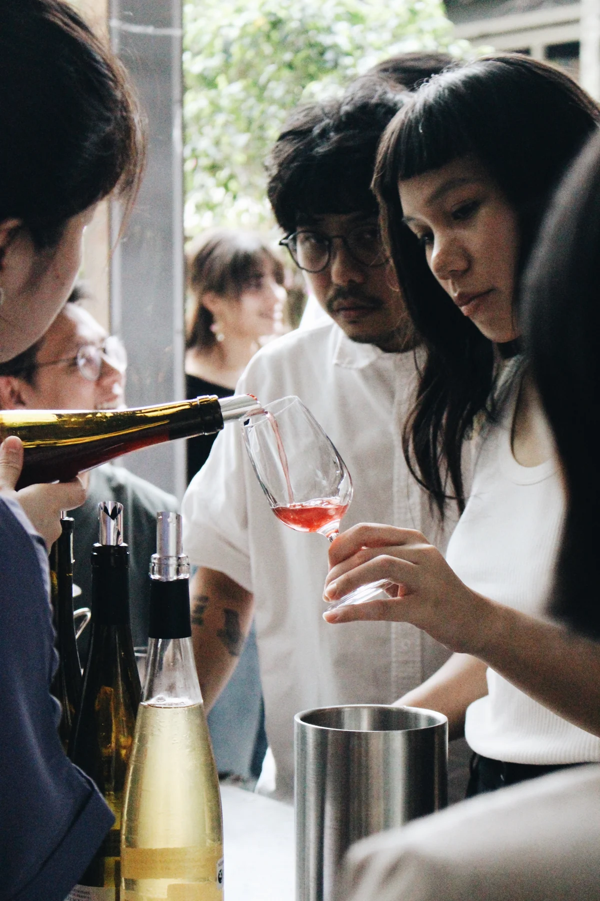 A glass being poured at an UNWINED tasting